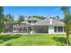 A lush backyard with a screened-in pool and patio area at 5550 Osprey Isle Ln, Orlando, FL 32819