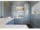 Stylish bar area showcasing marble countertops, custom cabinetry, and elegant fixtures ideal for hosting and enjoying refreshments at 5550 Osprey Isle Ln, Orlando, FL 32819