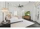 Modern bedroom features herringbone wood floors, a plush white rug, and stylish lighting fixtures at 5550 Osprey Isle Ln, Orlando, FL 32819