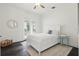 Cozy bedroom with neutral walls, dark hardwood floors, a queen-sized bed, and a glass door to the outside at 5550 Osprey Isle Ln, Orlando, FL 32819