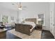 Bright bedroom with dark hardwood floors, neutral paint, and large windows for plenty of natural light at 5550 Osprey Isle Ln, Orlando, FL 32819