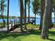 A boat dock on a beautiful lake surrounded by tropical trees at 5550 Osprey Isle Ln, Orlando, FL 32819