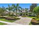 Beautiful circular driveway leading up to a stunning home with lush landscaping and mature palm trees at 5550 Osprey Isle Ln, Orlando, FL 32819