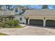 A beautiful two-story home with a three-car garage and a brick paved driveway at 5550 Osprey Isle Ln, Orlando, FL 32819
