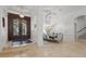 Elegant foyer with wood and iron doors, seamlessly connecting to a dining area with modern chandelier at 5550 Osprey Isle Ln, Orlando, FL 32819
