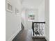 Bright hallway with dark hardwood floors in a herringbone pattern and an arched window at 5550 Osprey Isle Ln, Orlando, FL 32819