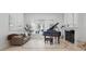 A spacious living room with marble floors, bright windows, and a grand piano at 5550 Osprey Isle Ln, Orlando, FL 32819