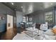 Stylish den with dark walls, custom bar, and ample seating creates a relaxing and elegant space for entertaining guests at 5550 Osprey Isle Ln, Orlando, FL 32819