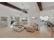 Spacious living room with a large sectional sofa, marble coffee table, and views of the outdoors through expansive windows at 5550 Osprey Isle Ln, Orlando, FL 32819