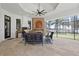 Inviting outdoor living space with stone fireplace, built-in grill, and views of the water at 5550 Osprey Isle Ln, Orlando, FL 32819