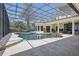 A beautiful screened-in pool and patio area with ample seating, and a relaxing in-ground spa at 5550 Osprey Isle Ln, Orlando, FL 32819
