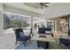 Elegant outdoor pool patio with covered seating area and views of the pool at 5550 Osprey Isle Ln, Orlando, FL 32819