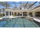 A beautiful screened-in pool and patio area with ample seating, and a relaxing in-ground spa at 5550 Osprey Isle Ln, Orlando, FL 32819