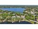 Lakefront home nestled among lush trees and featuring a private dock and boat lift at 5550 Osprey Isle Ln, Orlando, FL 32819