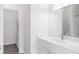 Modern bathroom vanity with a large mirror and open view to the walk-in closet at 5953 Westgate Dr # 1823, Orlando, FL 32835