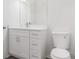 Bathroom featuring a white vanity with stone countertop and modern faucet, and a toilet at 5953 Westgate Dr # 1823, Orlando, FL 32835