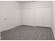 A bright bedroom shows two closets with white painted doors and grey vinyl floors at 5953 Westgate Dr # 1823, Orlando, FL 32835