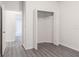 Bright bedroom features an open closet, grey vinyl floors, and white paint at 5953 Westgate Dr # 1823, Orlando, FL 32835