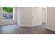 Bright bedroom with grey vinyl floors, a window with outside view, and white paint at 5953 Westgate Dr # 1823, Orlando, FL 32835