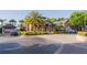 Community center showcasing elegant architecture, lush landscaping, and ample parking at 5953 Westgate Dr # 1823, Orlando, FL 32835