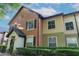 Charming multi-toned townhouse exterior with well-maintained landscaping and classic architectural details at 5953 Westgate Dr # 1823, Orlando, FL 32835