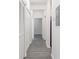 Hallway with wood floors, white walls, and a closet door on one side at 5953 Westgate Dr # 1823, Orlando, FL 32835