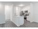 Bright white kitchen features stainless steel appliances and a breakfast bar overlooking the living area at 5953 Westgate Dr # 1823, Orlando, FL 32835