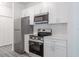 Contemporary kitchen featuring stainless steel appliances, white cabinetry, and modern finishes at 5953 Westgate Dr # 1823, Orlando, FL 32835