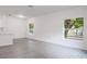 Bright living room featuring grey vinyl floors, recessed lighting, and views from two windows at 5953 Westgate Dr # 1823, Orlando, FL 32835