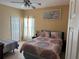 Serene bedroom featuring a comfortable bed, ceiling fan, and bright natural light at 708 Pincon Ln, Kissimmee, FL 34759