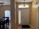 Inviting foyer featuring tile flooring, decorative lighting, and a view into the dining area at 708 Pincon Ln, Kissimmee, FL 34759