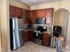 Well-equipped kitchen with stainless steel appliances, tile backsplash, and wood cabinetry at 708 Pincon Ln, Kissimmee, FL 34759