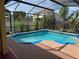 Screened-in pool area with brick pavers, a pool, and landscaping at 708 Pincon Ln, Kissimmee, FL 34759