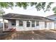 View of the back of the house with covered porch and windows at 7333 Radiant Cir, Orlando, FL 32810