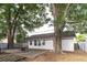 View of house from backyard featuring mature shade trees and brick patio area at 7333 Radiant Cir, Orlando, FL 32810
