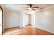 Bedroom featuring hardwood floors, a ceiling fan and an open closet at 7333 Radiant Cir, Orlando, FL 32810