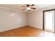 Bedroom with hardwood floors, a ceiling fan and sliding glass door at 7333 Radiant Cir, Orlando, FL 32810