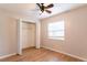 Bright bedroom featuring a ceiling fan, hardwood floors, and an open closet at 7333 Radiant Cir, Orlando, FL 32810