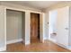 Bedroom with open closets, laminate flooring, and white trim at 7333 Radiant Cir, Orlando, FL 32810