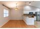 Well lit dining area featuring a decorative chandelier and hardwood floors at 7333 Radiant Cir, Orlando, FL 32810