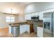 Cozy kitchen boasts granite countertops, stainless steel appliances, and an adjacent dining area at 7333 Radiant Cir, Orlando, FL 32810