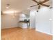 Bright living area with hardwood floors, vaulted ceiling, and seamless transition to the kitchen at 7333 Radiant Cir, Orlando, FL 32810