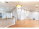 Open-concept living space boasts hardwood floors, vaulted ceiling, decorative lighting, and bar-height seating at 7333 Radiant Cir, Orlando, FL 32810