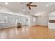 Bright, open living area with hardwood floors, recessed lighting, ceiling fan, and large windows at 7333 Radiant Cir, Orlando, FL 32810
