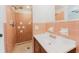 Bathroom featuring tile walls, a shower, a sink with vanity, and a large mirror above the sink at 735 Baltimore Dr, Orlando, FL 32810