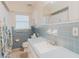 Bathroom featuring tile walls, a toilet, a sink with vanity, and a window that lets in plenty of natural light at 735 Baltimore Dr, Orlando, FL 32810