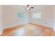 Bedroom with hardwood floors, a ceiling fan, and two windows that let in plenty of natural light at 735 Baltimore Dr, Orlando, FL 32810