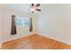Bedroom with hardwood floors, a ceiling fan, and a window with curtains that let in plenty of natural light at 735 Baltimore Dr, Orlando, FL 32810