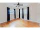 Bedroom featuring hardwood floors, windows on two walls, a ceiling fan, and curtains at 735 Baltimore Dr, Orlando, FL 32810