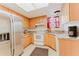 Well-lit kitchen featuring stainless steel appliances, wood cabinets, and light countertops at 735 Baltimore Dr, Orlando, FL 32810